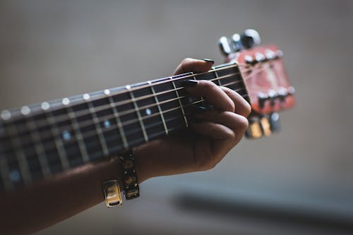 Person Playing Guitar