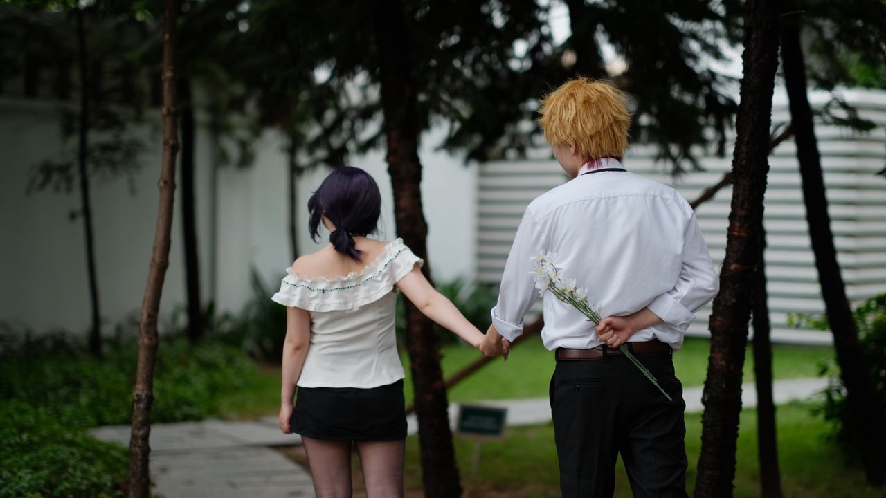 a couple holding hands with a romantic gesture outdoors sharing a tend