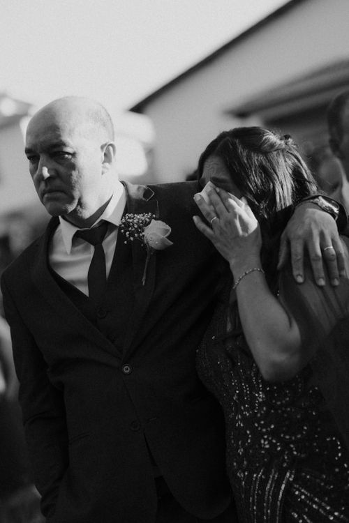 Free A heartfelt moment between a man and woman at a wedding, captured in black and white. Stock Photo