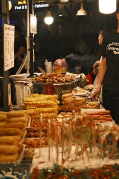 A lively night market food stall in Vietnam showcasing an array of delicious street food treats.