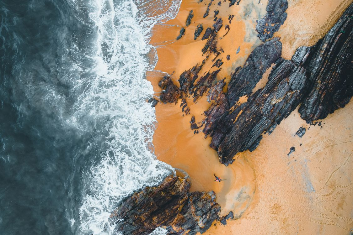Aerial View of Rugged Coastline with Waves · Free Stock Photo