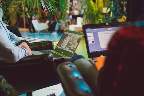 Free Person Holding Black And Silver Laptops Stock Photo