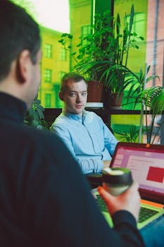 Two business professionals discussing plans in a vibrant office space.