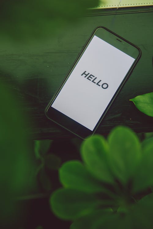 Free Black Smartphone on Green Table Stock Photo