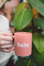 Photo Of Person Holding Pink Mug