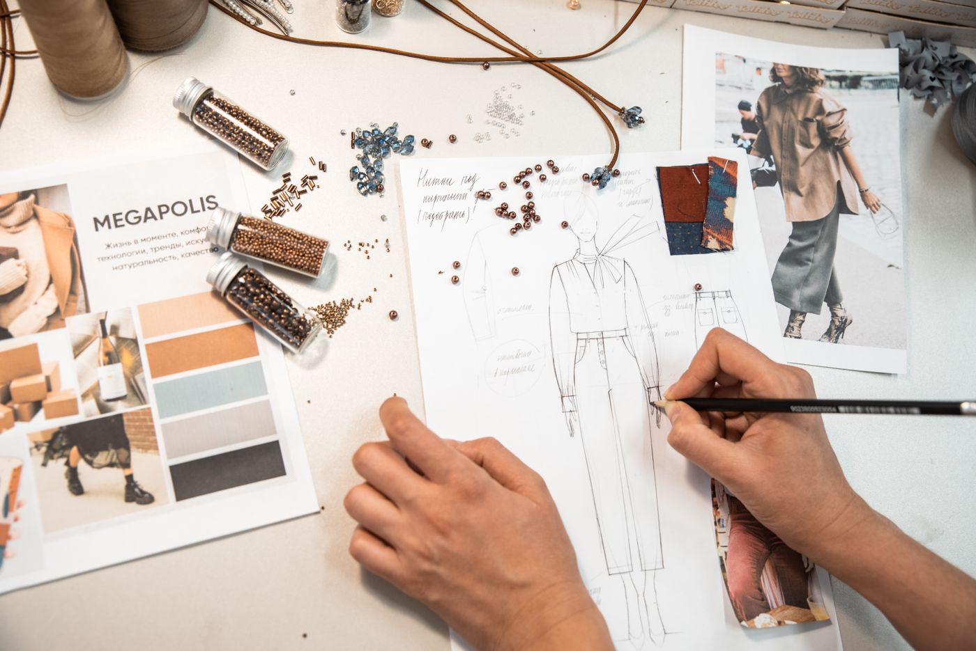 Creative fashion-design workspace with sketches and materials