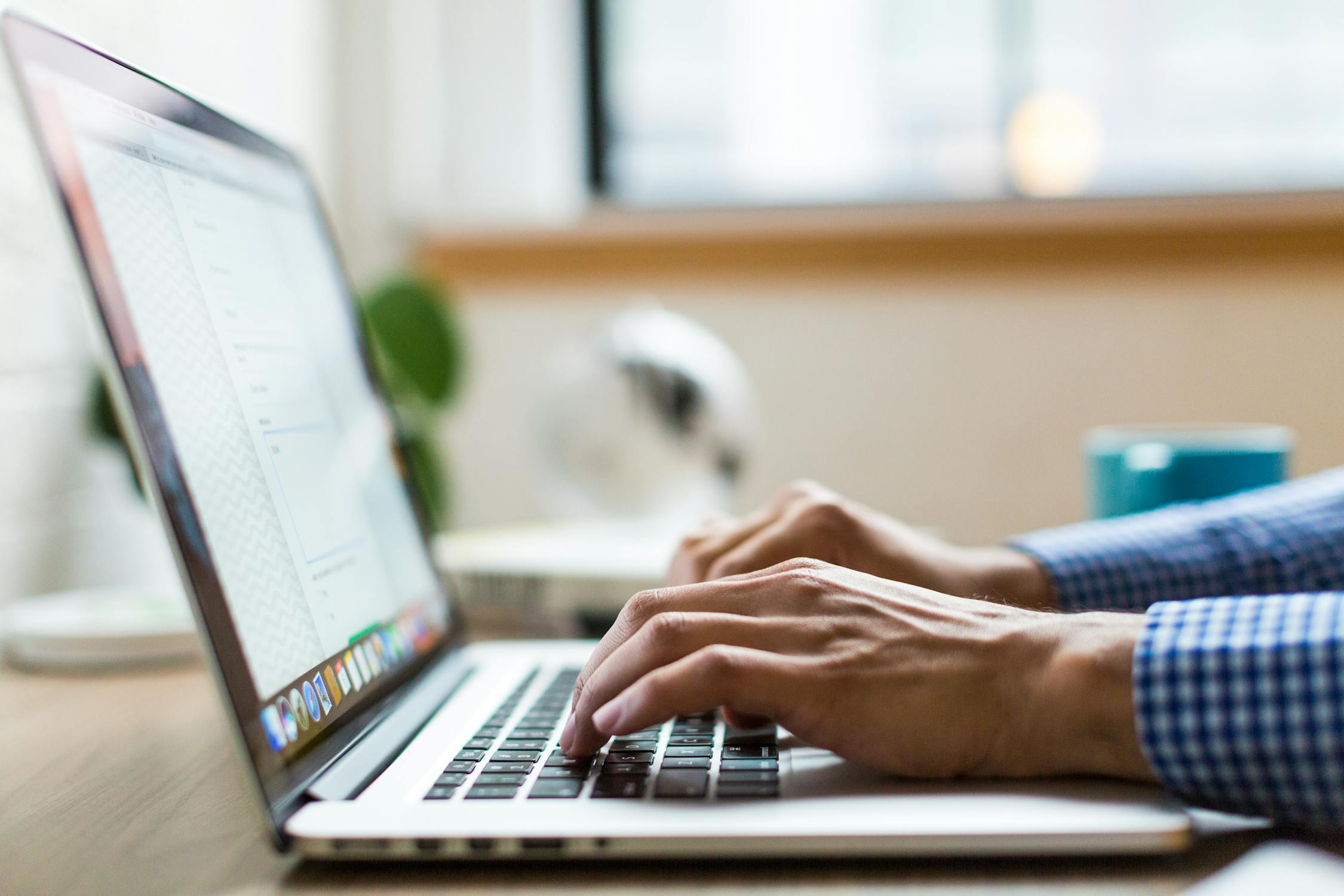 Photo of person on laptop in blue shirt