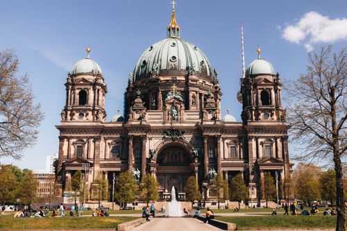 Free View of the historic Berlin Cathedral and fountain in Lustgarten on a sunny day, capturing the vibrant park atmosphere. Stock Photo