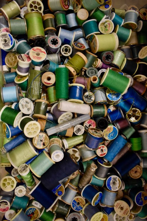 Free A variety of colorful thread spools perfect for sewing and crafting projects. Stock Photo