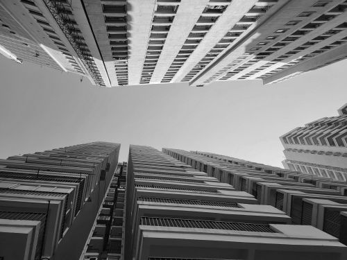 Free Black and white image of towering city skyscrapers from a dramatic upward angle. Stock Photo
