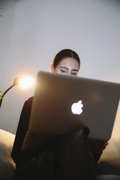 Photo Of Woman Sitting Beside Lamp