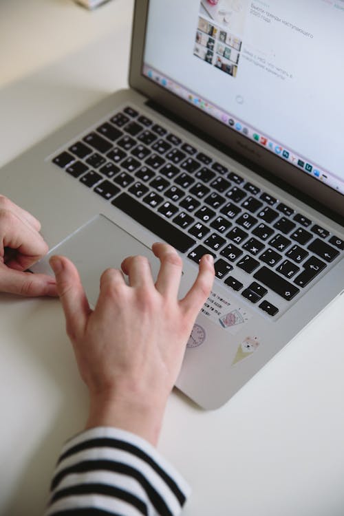 Person Using Silver Macbook Pro