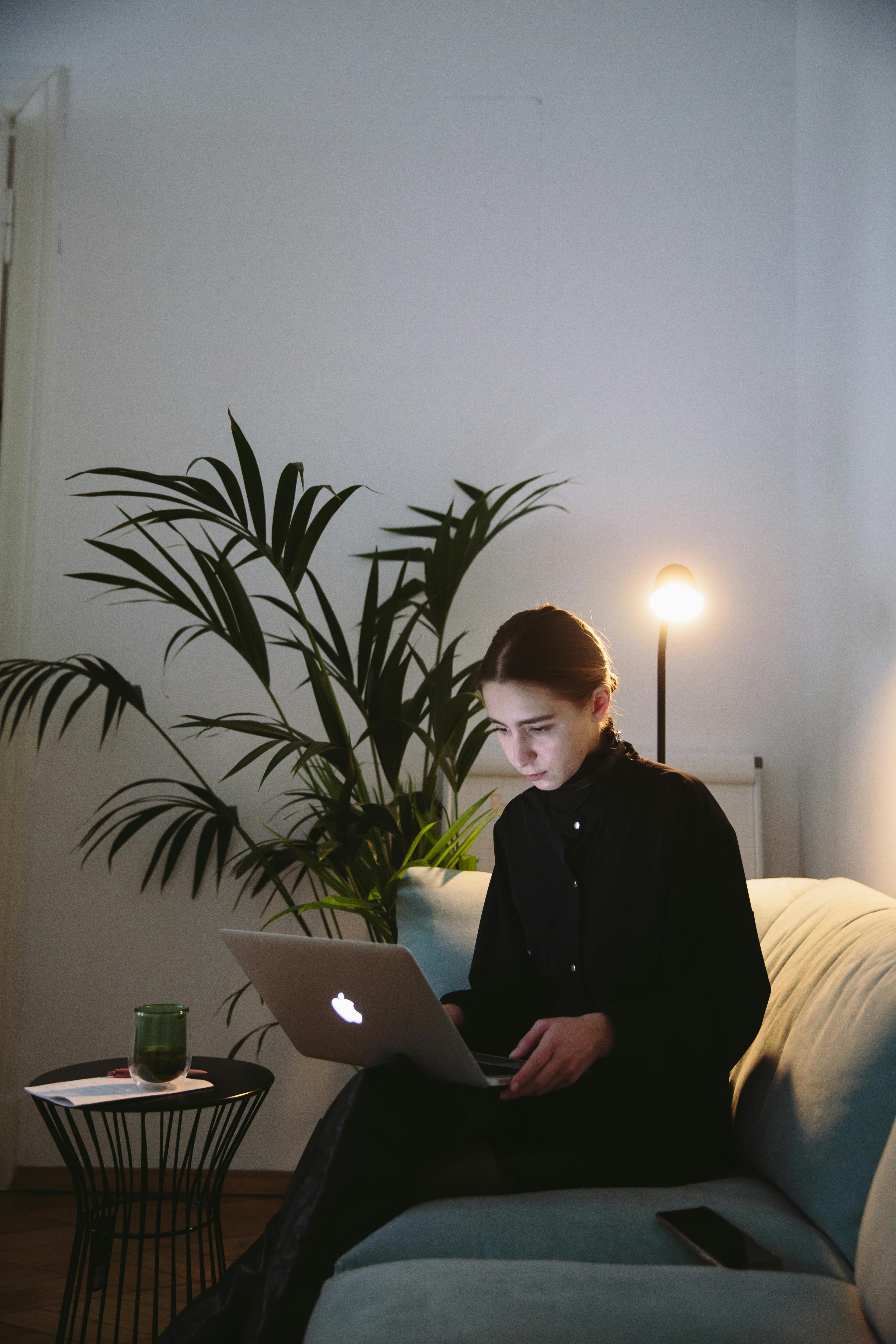 Free Photo Of Woman Sitting On Grey Sofa Stock Photo