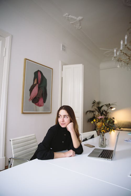 Woman in Black Long Sleeve Shirt Sitting on Chair