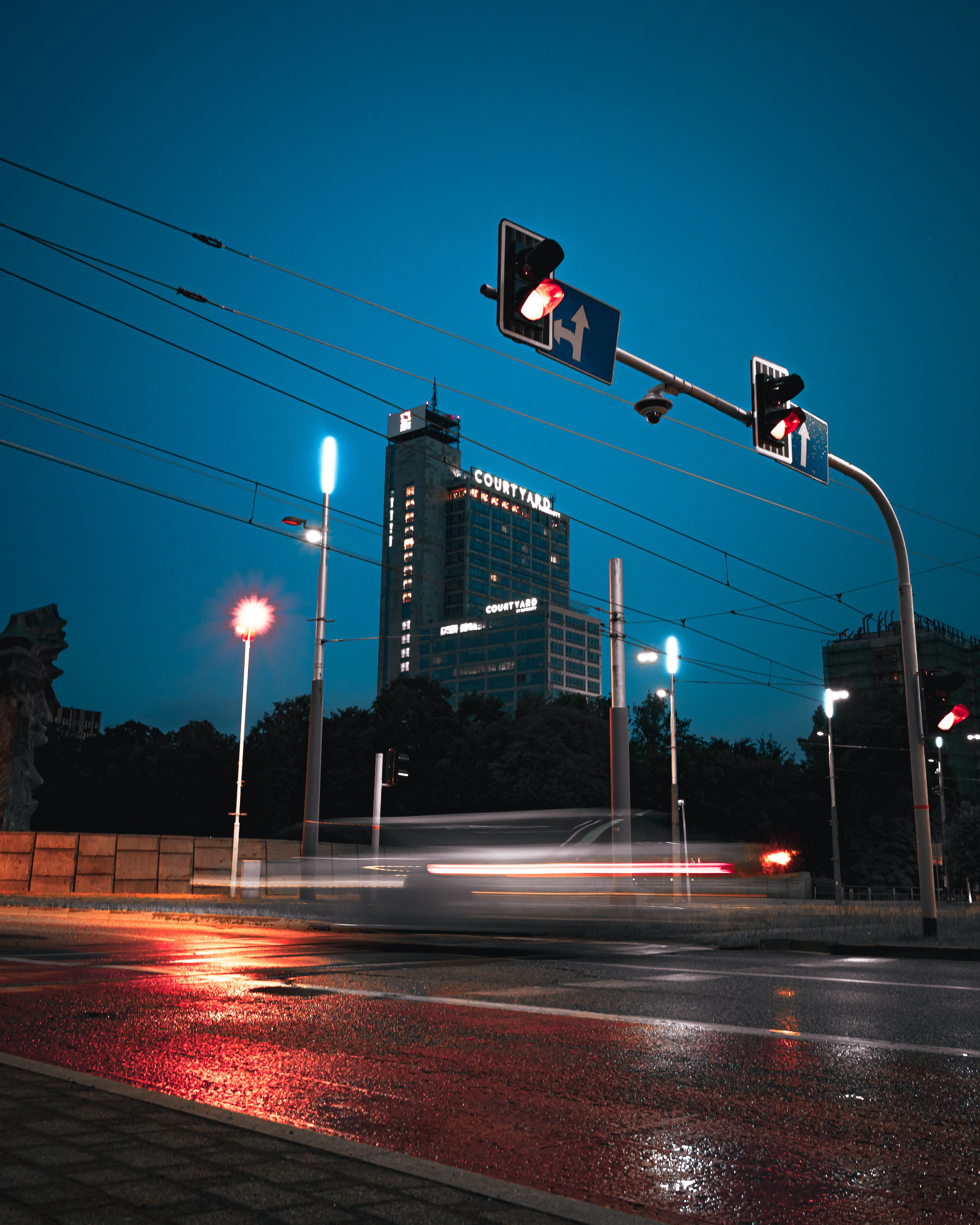 Dynamic long exposure of city traffic with a view of a lit skyscraper at night.