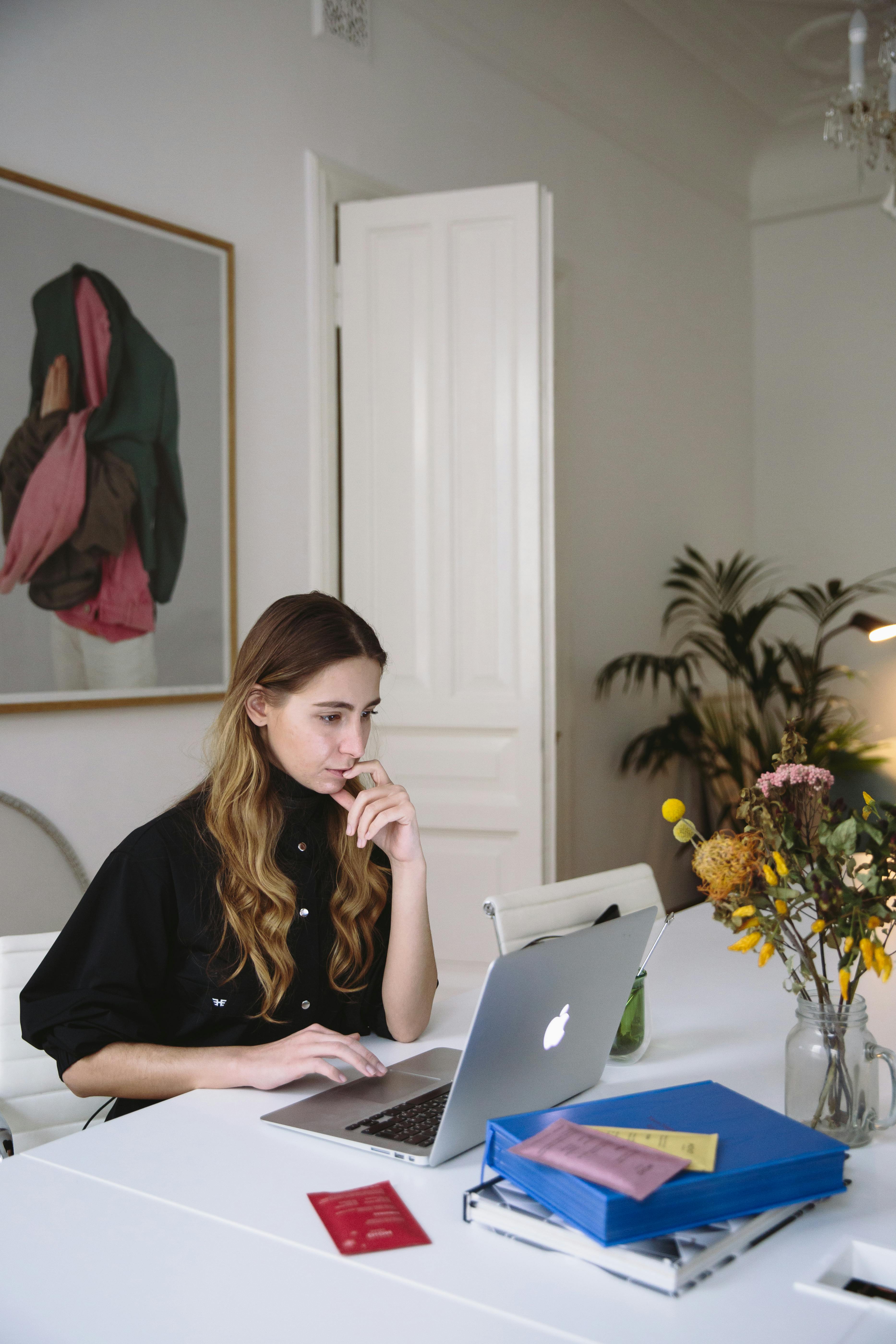 photo of woman using laptop