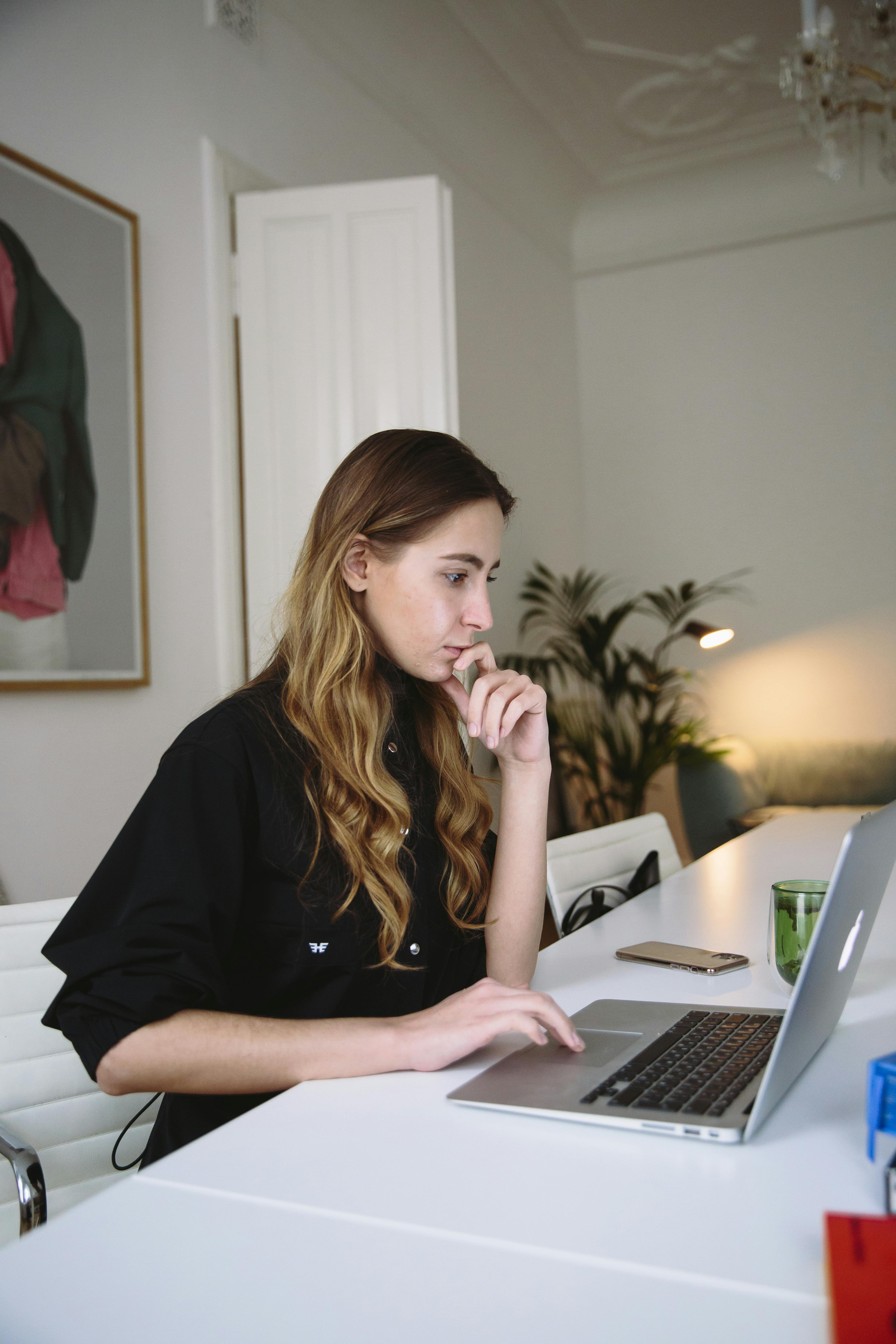 photo of woman using laptop