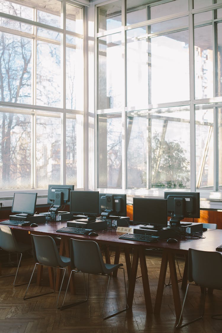 Photo Of Computers On Wooden Table