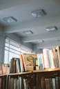 Photo Of Books On Brown Shelves