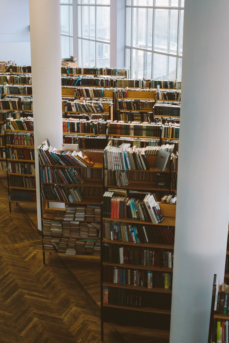 A large library with rows of wooden bookshelves
