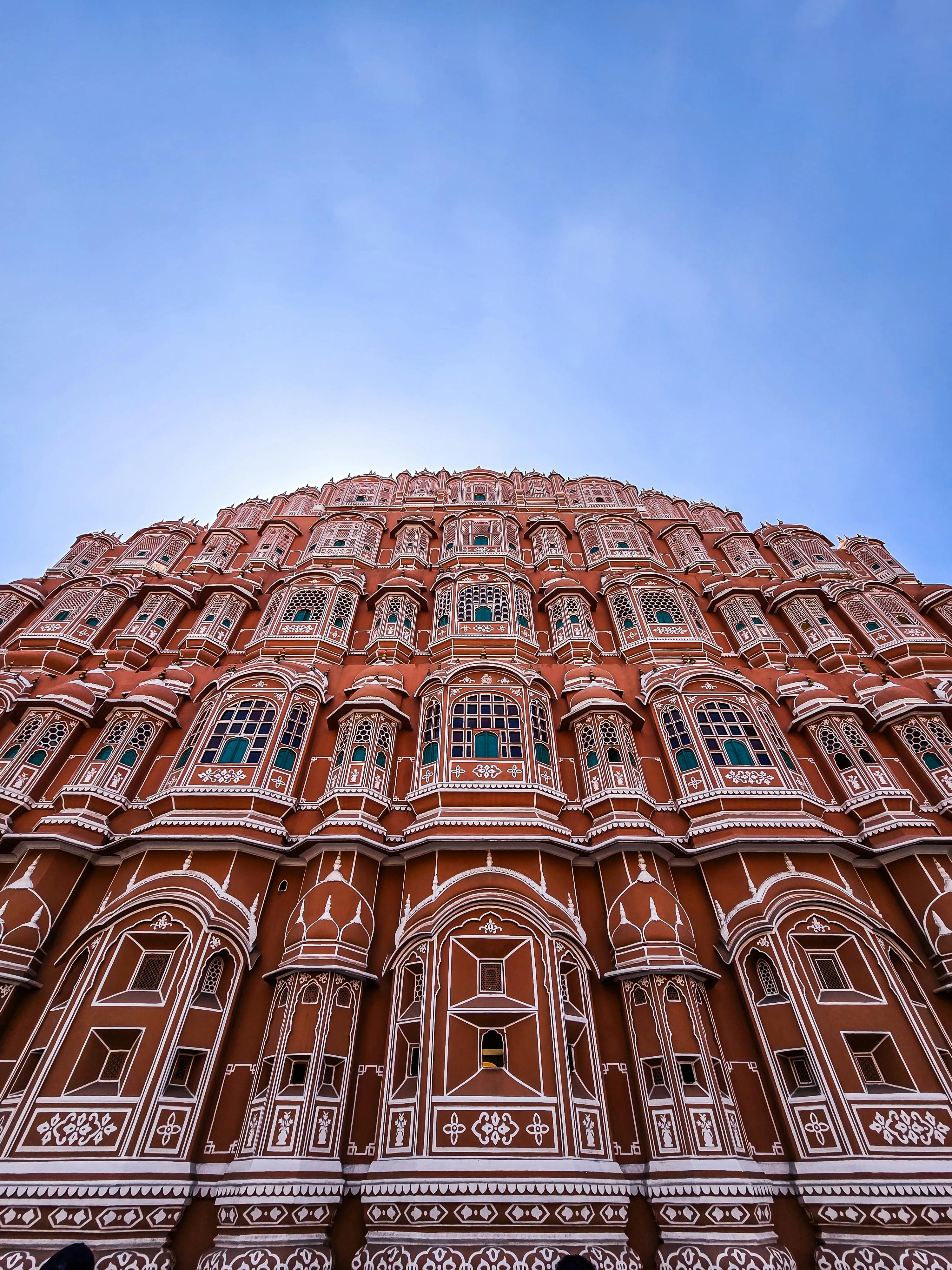 Stunning view upwards of Jaipur's iconic Hawa Mahal against a crisp blue sky.