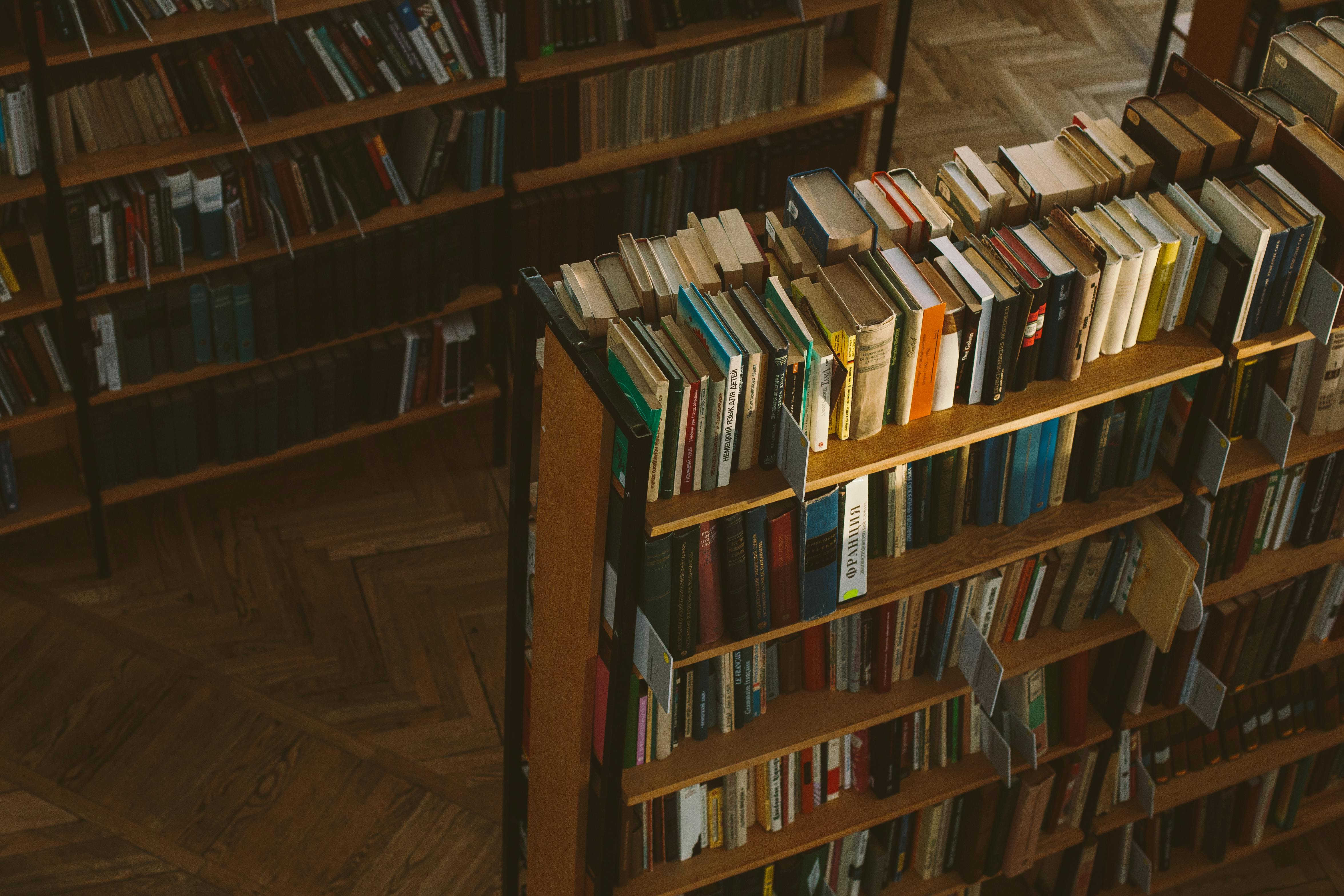 books on brown wooden shelf