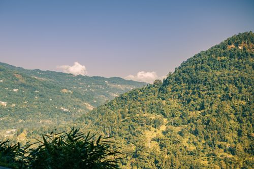 Free A stunning view of lush green hills under a clear sky, perfect nature scenery. Stock Photo