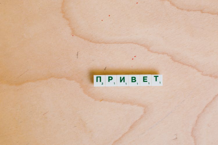 Photo Of Alphabet Tiles On Wooden Surface