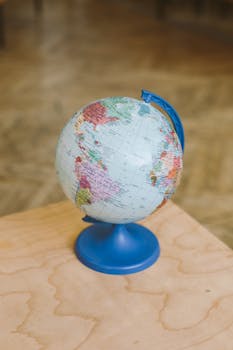 Photo by Polina Zimmerman A globe on a wooden table indoors, symbolizing education and geography.