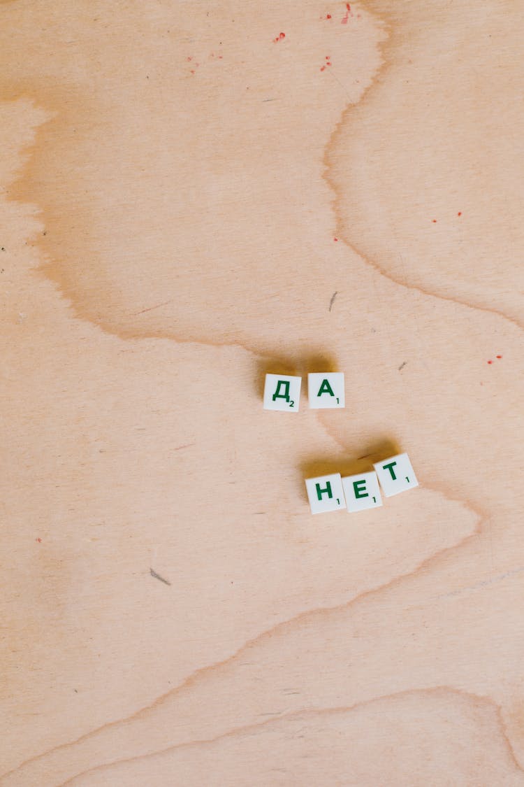 Photo Of Alphabet Tiles On Wooden Surface