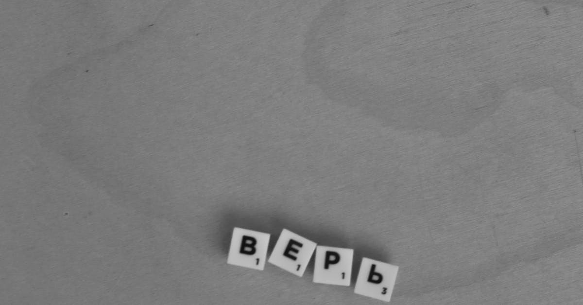 Photo by Polina Zimmerman Black and white photo of Cyrillic letters forming 'верь' on a wooden surface.