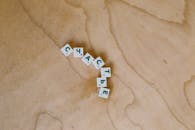Photo Of Alphabet Tiles On Wooden Surface