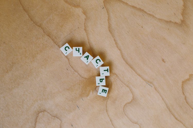 Photo Of Alphabet Tiles On Wooden Surface