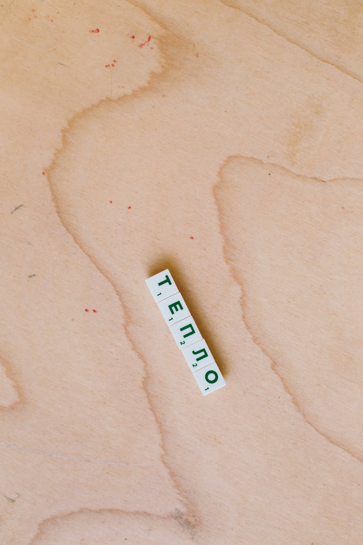 Photo Of Alphabet Tiles On Wooden Surface