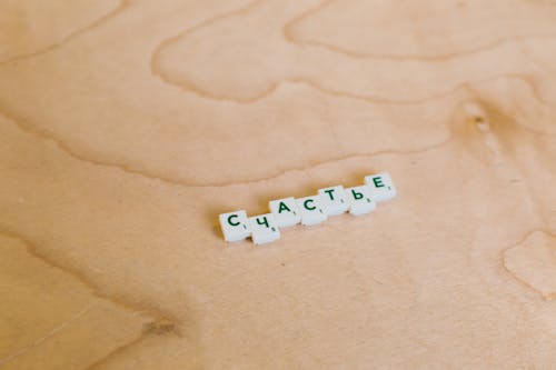 Free Photo Of Scrabble Pieces On Wooden Surface Stock Photo