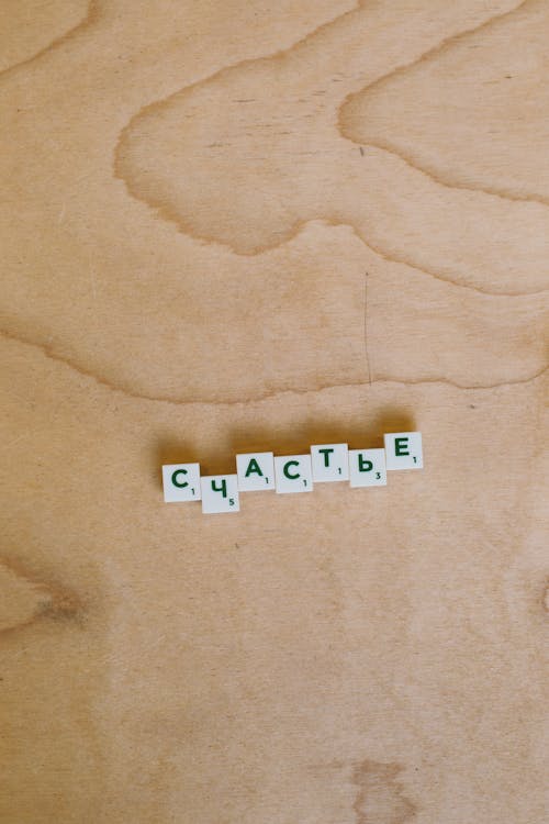 Photo Of Scrabble Pieces On Wooden Surface