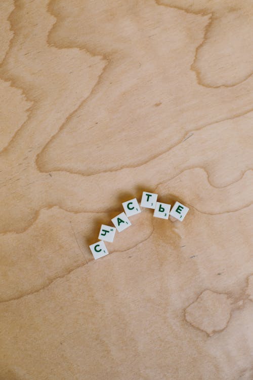 Photo Of Alphabet Tiles On Wooden Surface