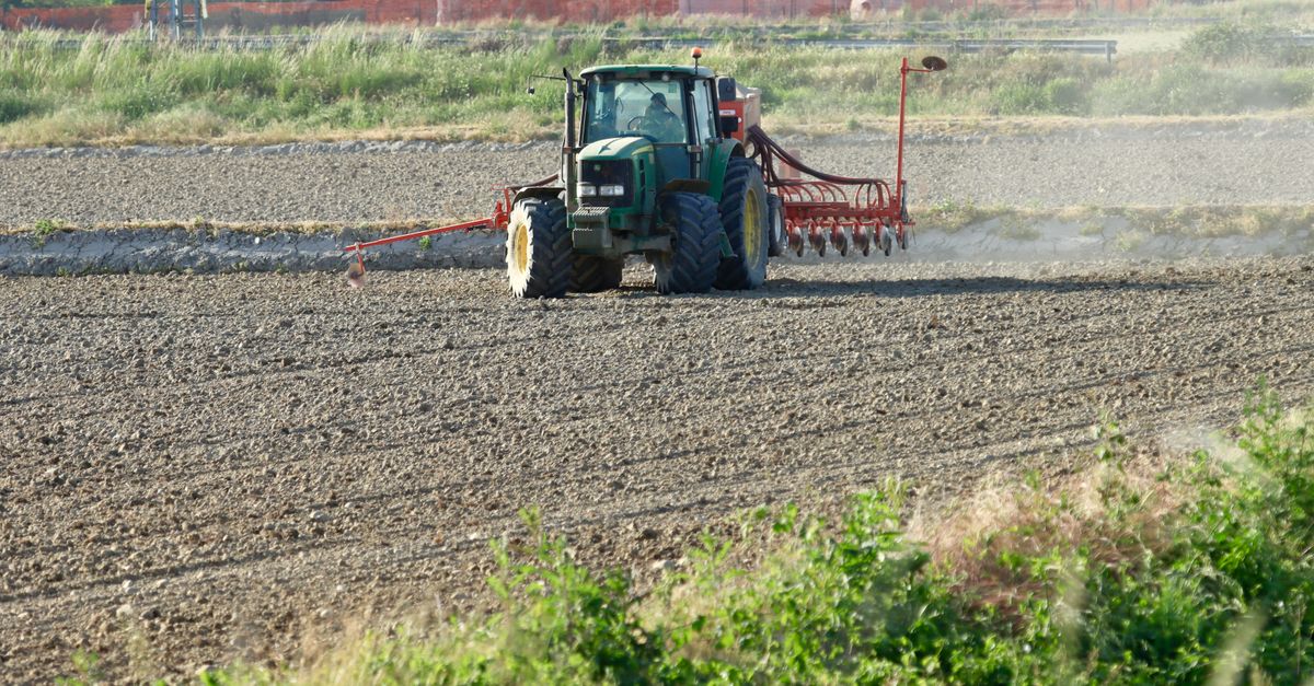 A tractor ploughing a field in Novara, Piedmont, Italy, showcasing rural agriculture.