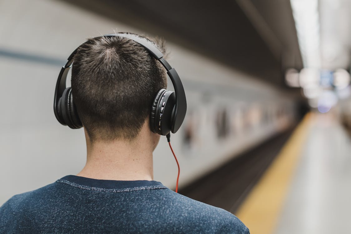 Free Man Listening Music on His Headphones Stock Photo