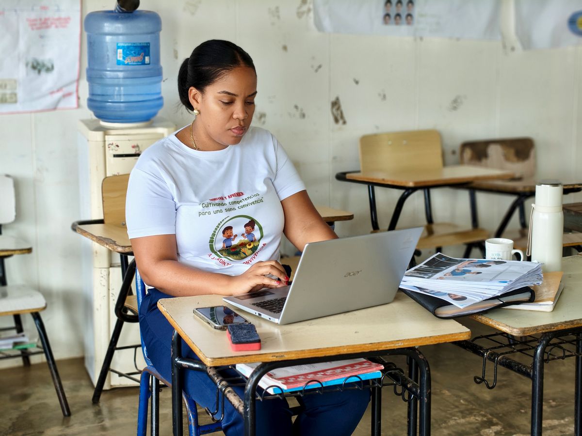 Teacher working on a laptop among classroom materials — Joaquin Reyes Ramos on Pexels