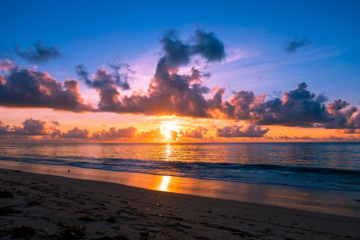 Breathtaking sunrise over the ocean waves at Mombasa Beach, Kenya. Perfect for travel enthusiasts.