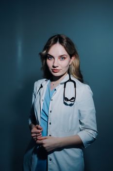 Portrait of a young female doctor in a lab coat with a stethoscope, exuding confidence.