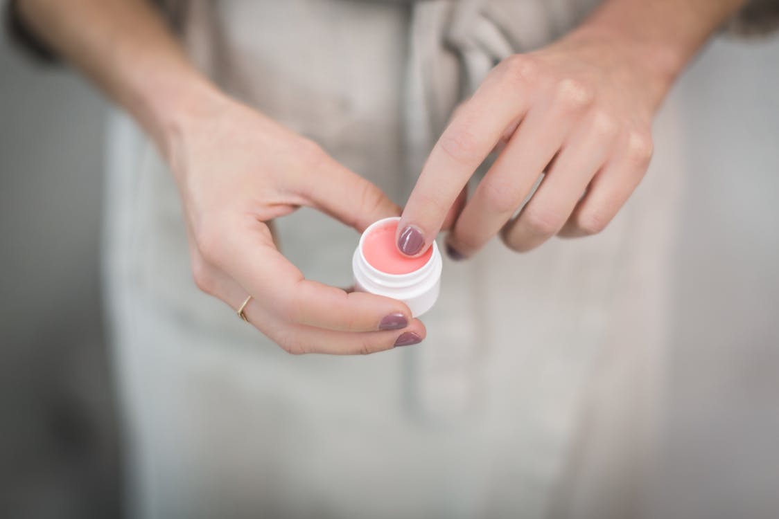 Free Person Holding Cream Container Stock Photo