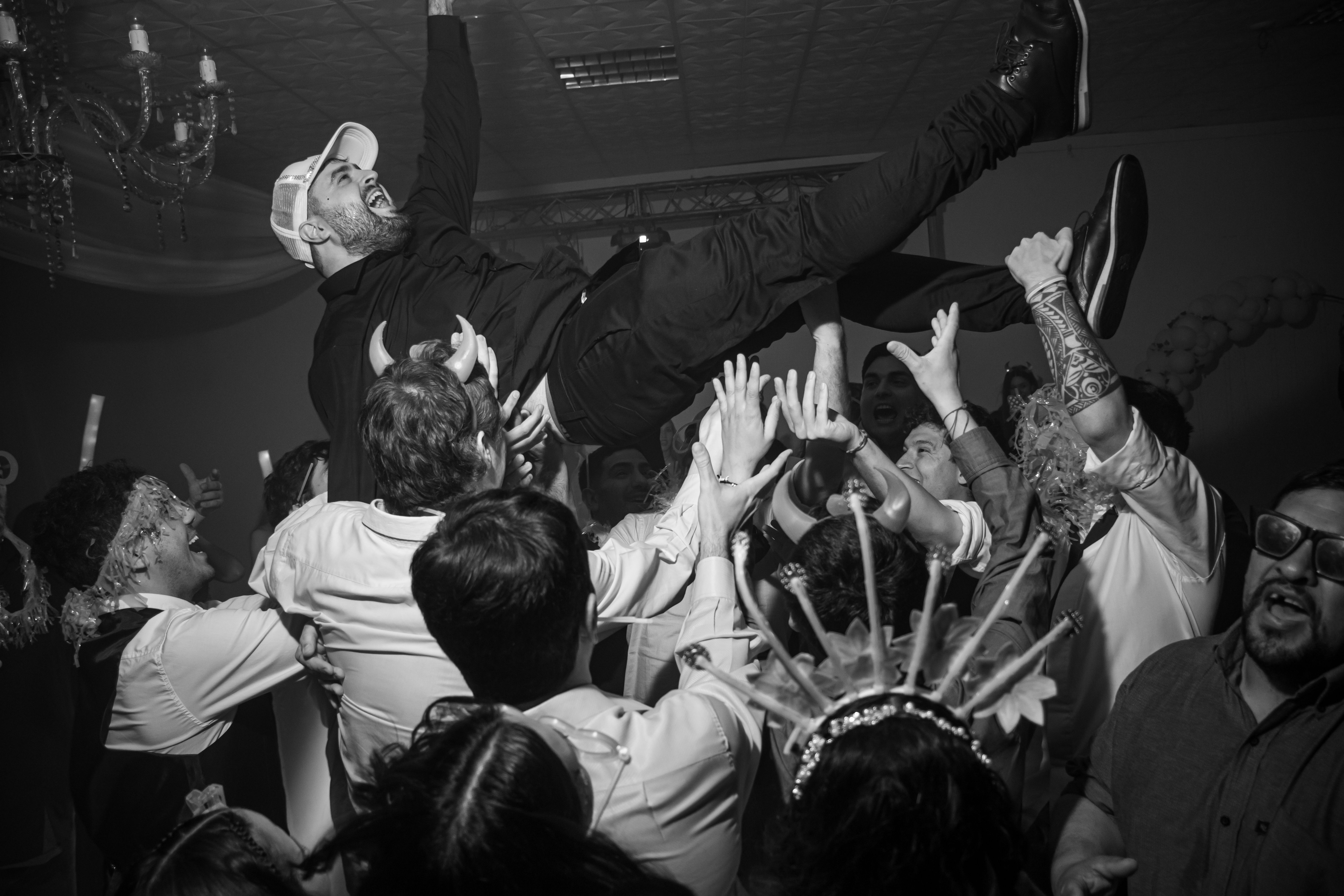 A joyful moment of crowd surfing at a lively indoor party.
