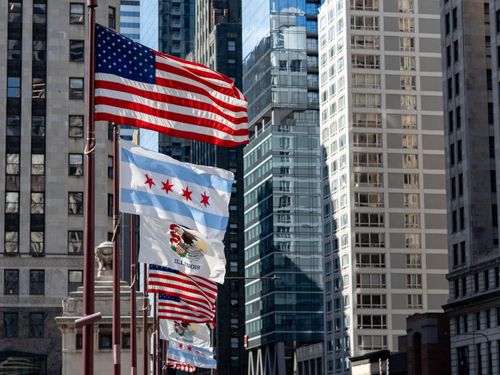 Free Flags of the United States and Chicago against a backdrop of downtown skyscrapers. Stock Photo