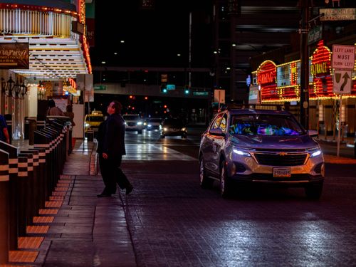 Free Vibrant night scene on Fremont Street, Las Vegas with cars and neon lights. Stock Photo