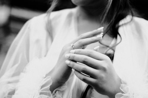 Free Close-up of a bride's hands and engagement ring, capturing an elegant moment in black and white. Stock Photo