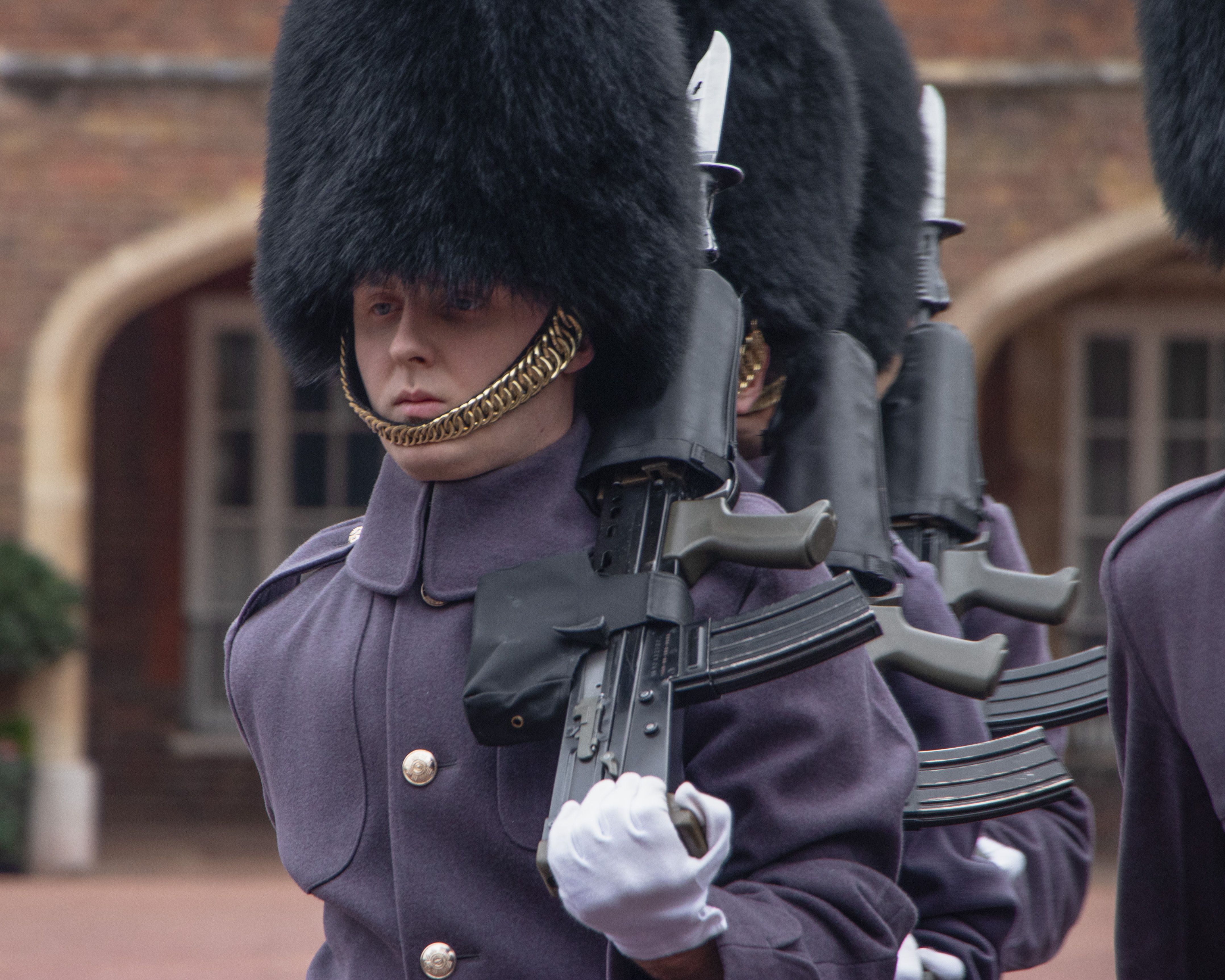 Foot Guards in ceremonial red tunics and bearskins at the Changing of the Guard.