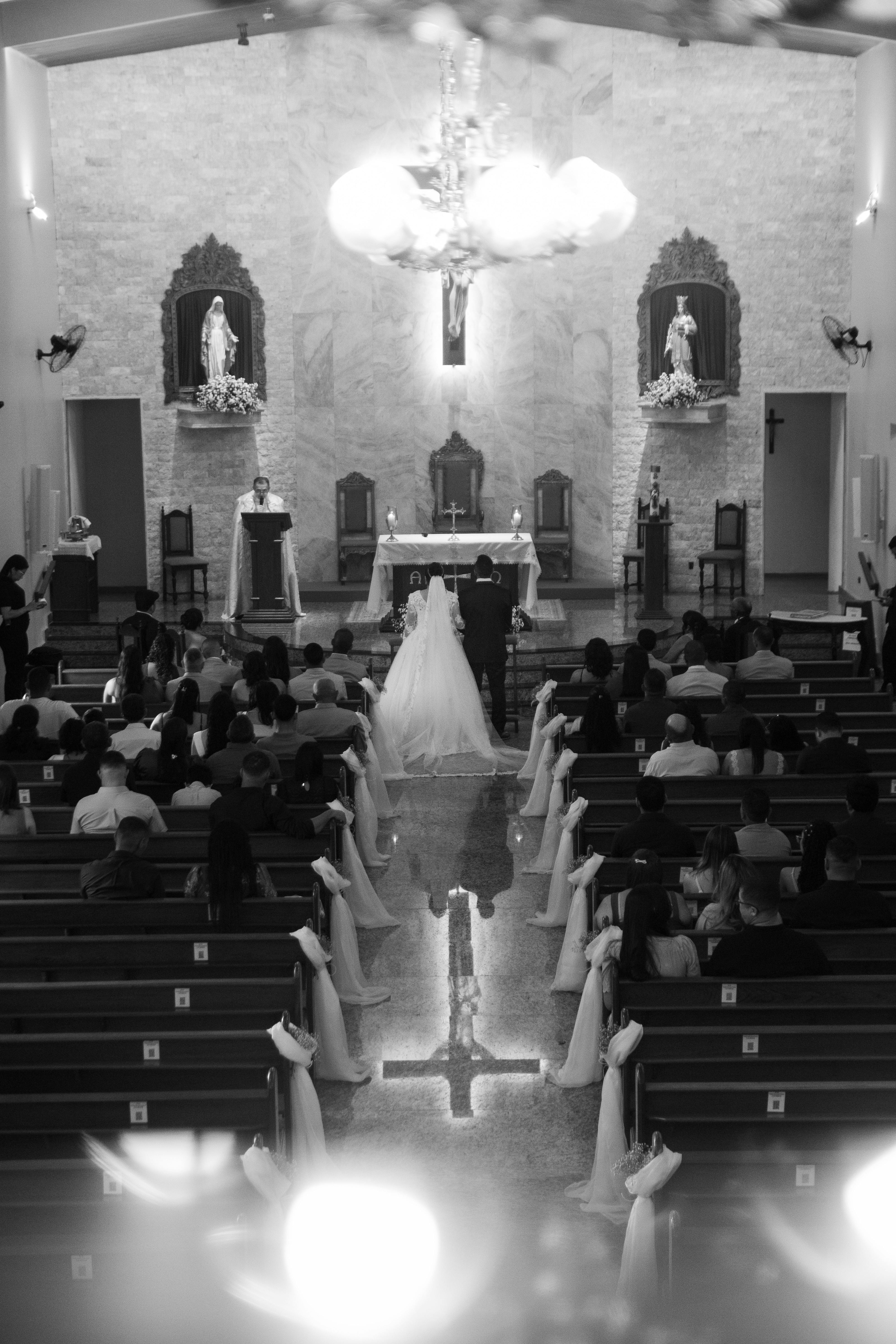 A bride and groom stand at the altar during a church wedding in Maceió, Brazil.