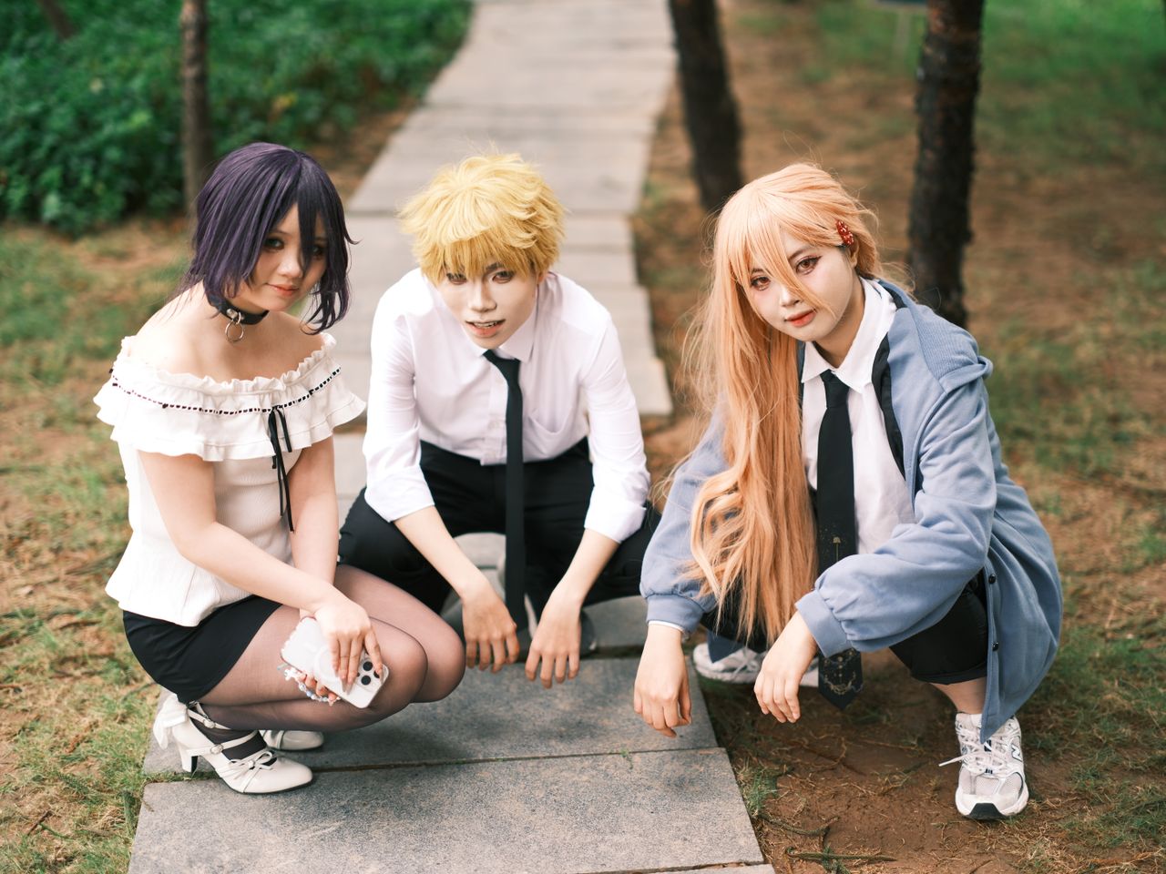 three adults in cosplay attire enjoy a day outdoors in vietnam showcas